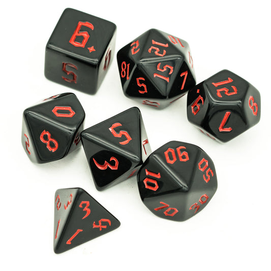 Juego de dados negros con letras de colores